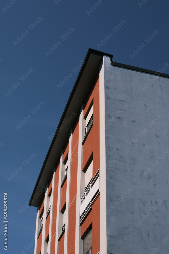 Modern building with a blue background, sunny day.