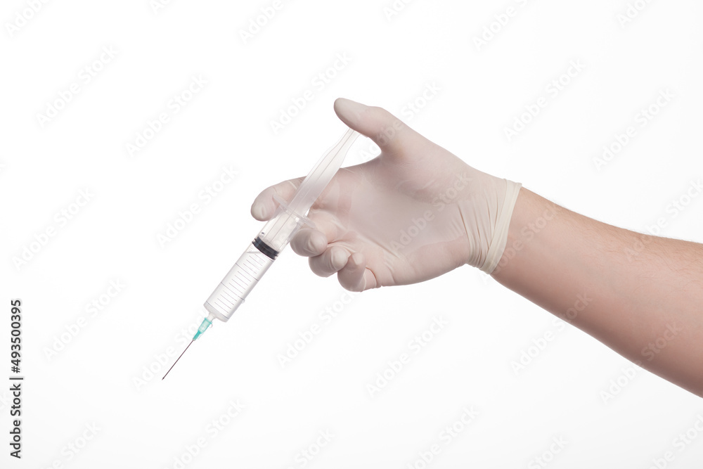 Syringe in man hand in gloves on a white background Syringe in man hand in gloves on a white background