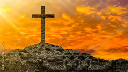 Easter or Religion background banner panorama religious greeting card - Old ruine stone wall and cross in the sunset, with orange glowing sky photo