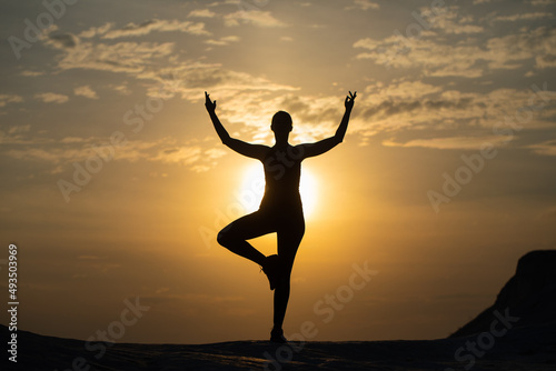 Yoga silhouette. Meditation girl on the background of sea during sunset. Fitness and healthy lifestyle.