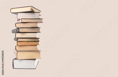 Banner with big books tower. Education, reading, information search concept. Place for text. High quality photo