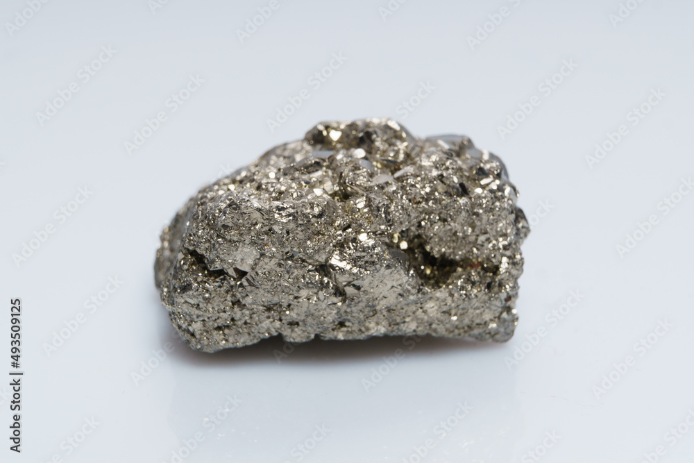 Raw crystalline pyrite (iron pyrite, fool's gold). Mineral pyrite from the group of sulfides. The mineral pyrite on a white background Raw crystalline pyrite (iron pyrite, fool's gold). Mineral pyrite from the group of sulfides. The mineral pyrite on a white background