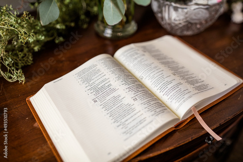 Open Bible on Brown Wood Table