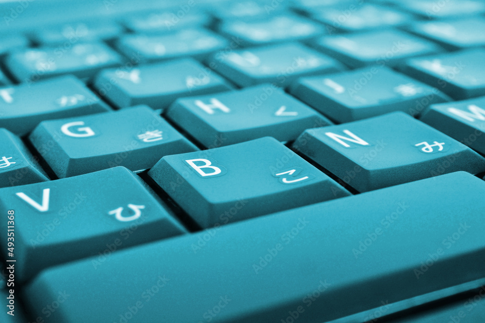 Japanese typing. Light blue laptop keyboard. Symbols on the buttons of hiragana. Electronic commerce in Japan. IT technologies and data storage. Bright tinted computer background or wallpaper. Macro Japanese typing. Light blue laptop keyboard. Symbols on the buttons of hiragana. Electronic commerce in Japan. IT technologies and data storage. Bright tinted computer background or wallpaper. Macro
