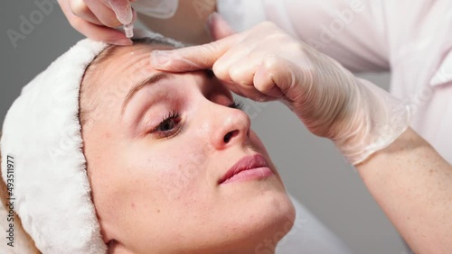 Injection at spa salon. Doctor hands in gloves. Closeup. Pretty female patient. Beauty treatment. Healthy skin procedure. Young women face. Plasmolifting rejuvenation photo