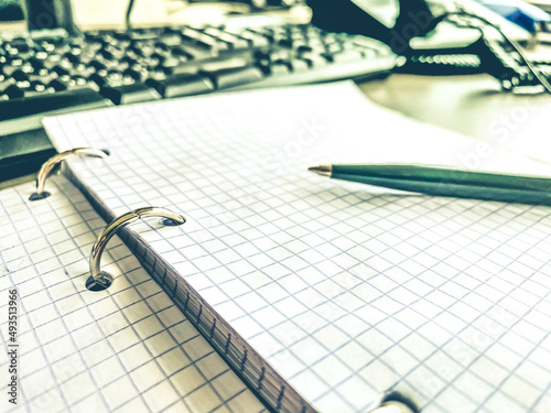 a sheet of white paper in a cage from a notebook. diary to record all personal affairs and tasks. lined sheet of paper. retro notepad, note taking on a sheet photo