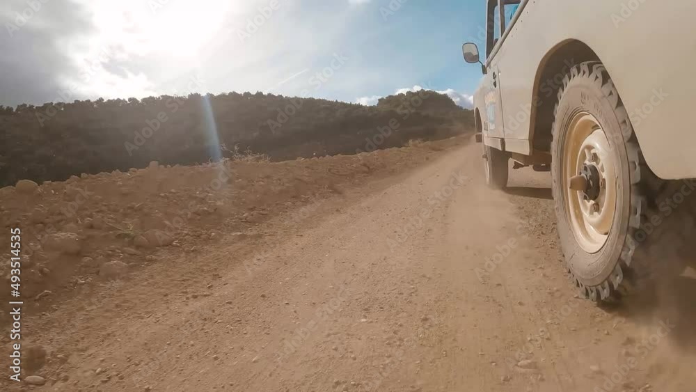 Low angle shot of a off-road pickup truck car driving on desert off-road during summer