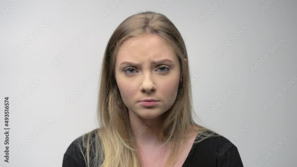 Angry young woman portrait in studio white background Angry young woman portrait in studio white background