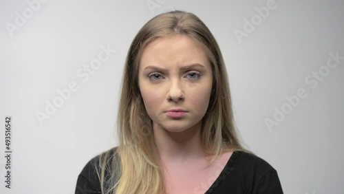 Angry young woman portrait in studio white background	