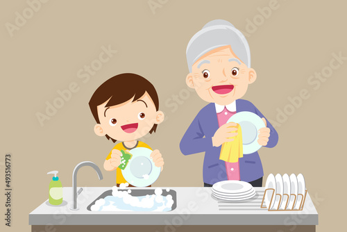 cute little boy washing dish with grandmother