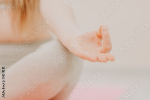 Two young sporty woman, fitness instructor in sportswear doing stretching and pilates on yoga mat in the studio with mirror. Female fitness yoga routine concept. Healthy lifestyle and harmony.