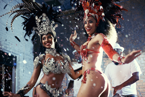Samba. Shot of two beautiful samba dancers performing in a carnival.