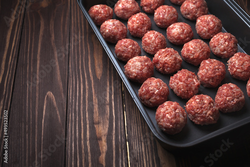 Raw meatballs on Baking trays are prepared and ready for baking in the oven. Place for text