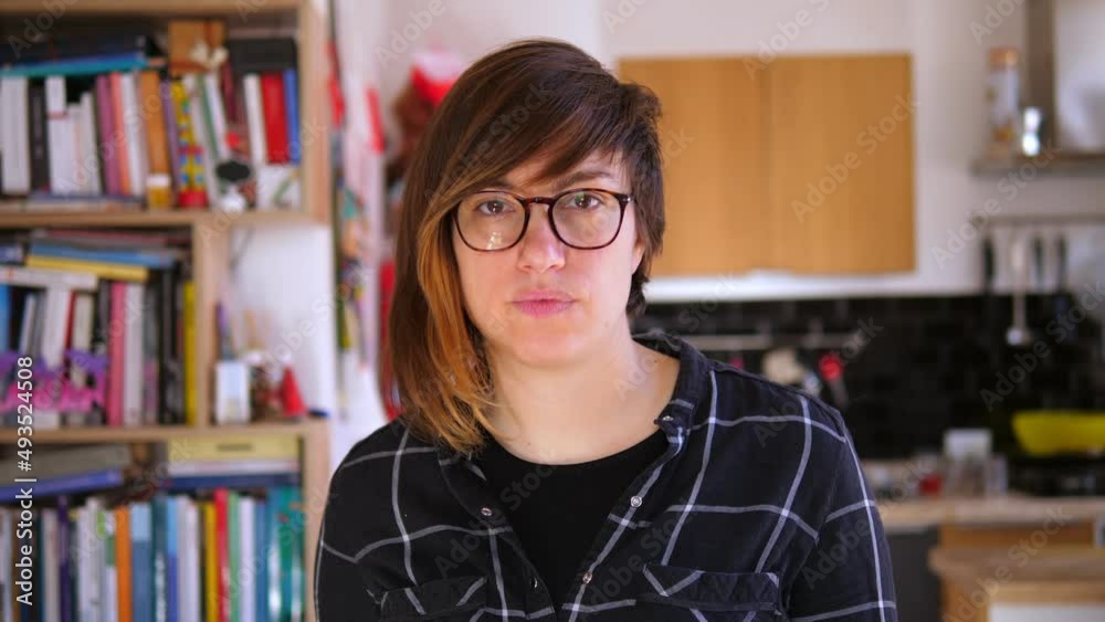 pensive unsmiling young woman looks serious at camera pensive unsmiling young woman looks serious at camera
