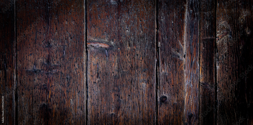 Dark wooden background. Detail of an ancient Venetian door. Dark wooden background. Detail of an ancient Venetian door.