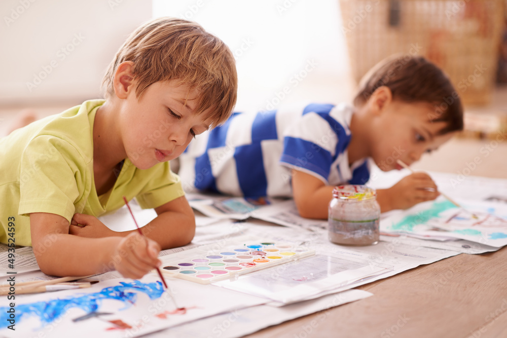 Unleashing their inner artists. Shot of two young boys painting pictures at home. Unleashing their inner artists. Shot of two young boys painting pictures at home.