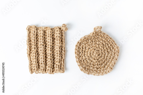 Natural washcloth made of craft thread for washing dishes. The concept of waste-free production , zero waste on white background isolated 