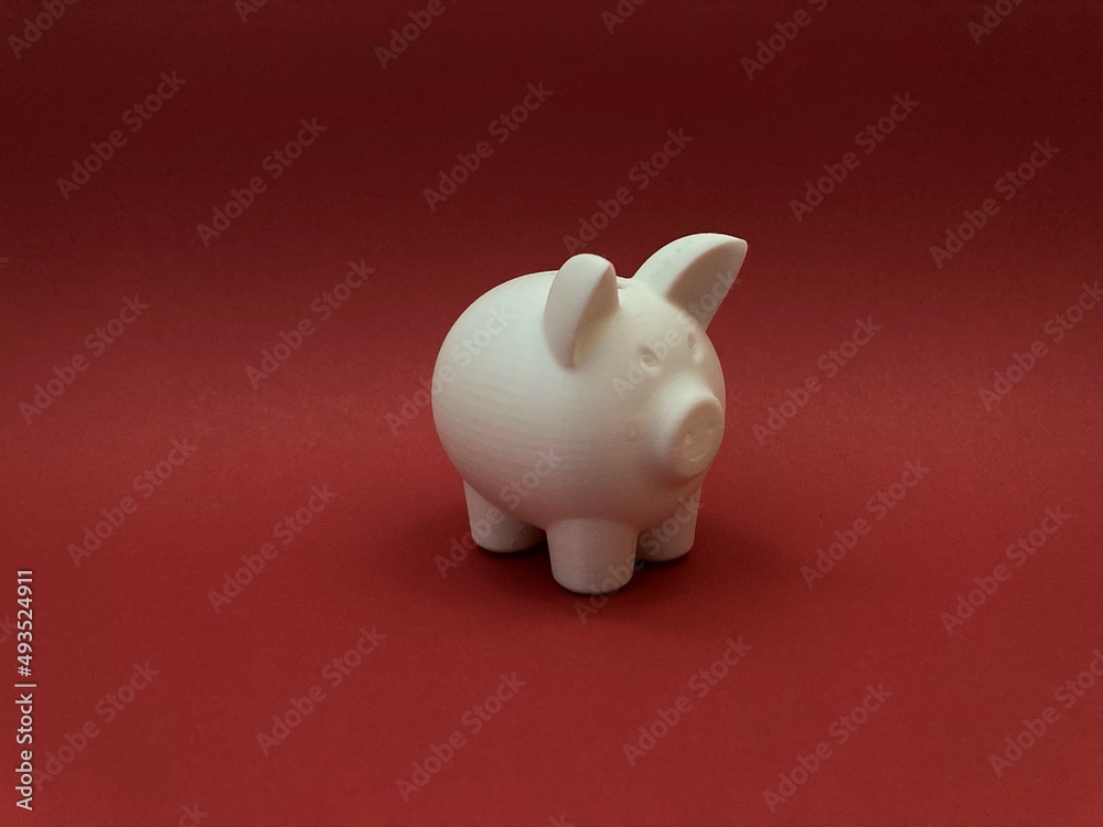 White piggy bank on a red background