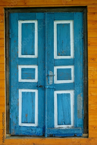 Close-up of old door painted blue and white. © Iwona