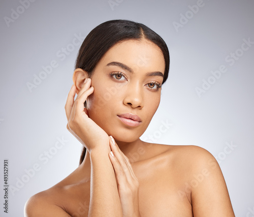 Dont forget to add confidence to your skincare routine. Studio shot of an attractive young woman posing against a grey background.