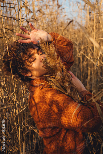Portrait of a beautiful young woman posing outdoor with her eyes closed
