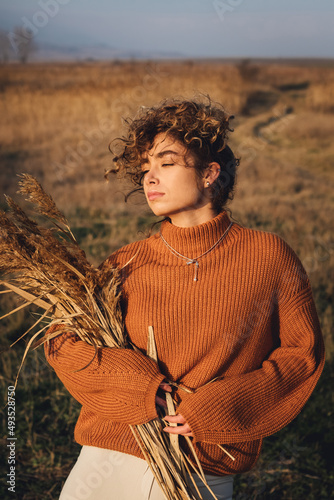 Portrait of a beautiful young woman while enjoying the sun with closed eyes