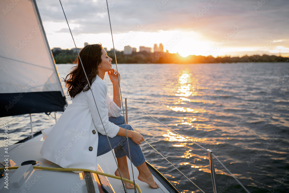 Bachelorette party on a yacht, a beautiful girl on a walk along the river. setting sun