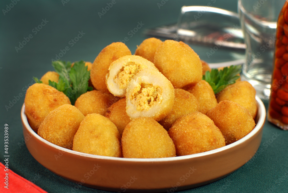 Traditional Brazilian fried snack made with chicken called Coxinha with one cut Traditional Brazilian fried snack made with chicken called Coxinha with one cut
