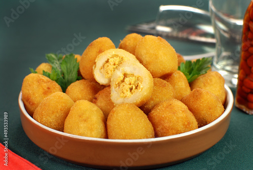 Traditional Brazilian fried snack made with chicken called Coxinha with one cut