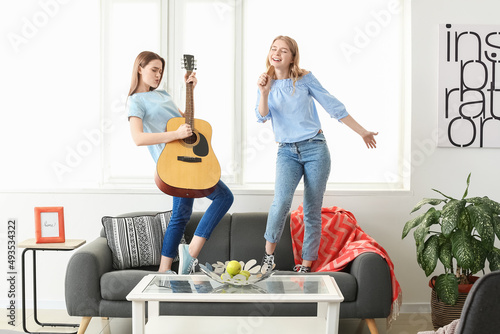 Happy young sisters having ...