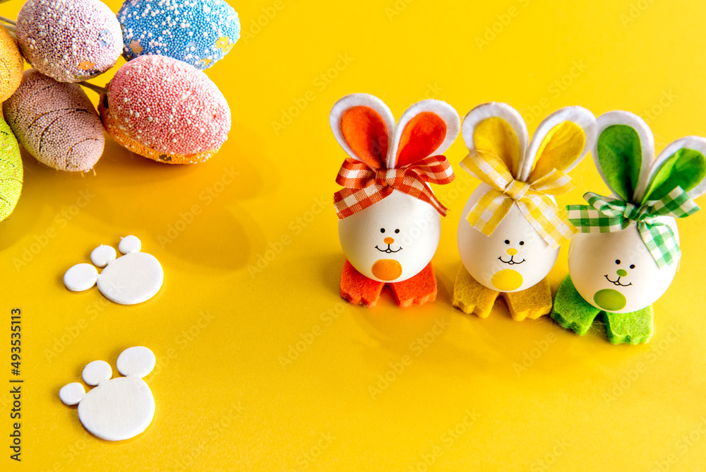 Easter decorated background, colorful easter eggs on yellow background.