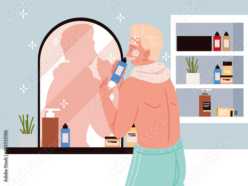 man applying face cream in bathroom