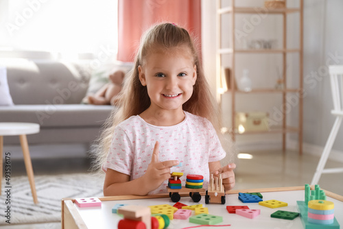 Cute little girl playing wi...