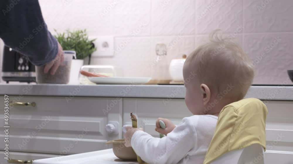 Father cooks breakfast in the kitchen with his little son. High quality 4k footage Father cooks breakfast in the kitchen with his little son. High quality 4k footage