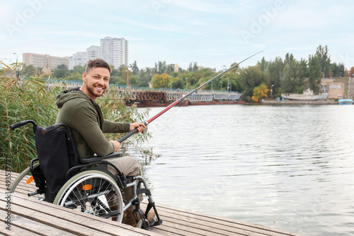Man in wheelchair fishing o...