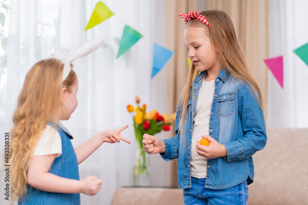 little girls with Easter eggs play the game stone paper scissors little girls with Easter eggs play the game stone paper scissors
