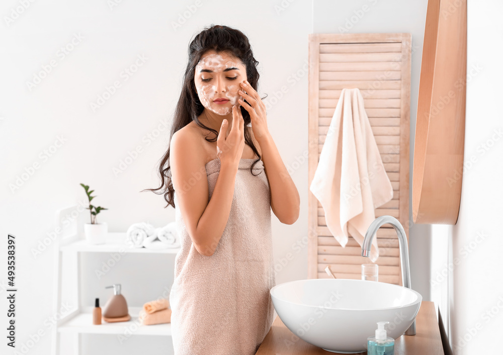 Morning of beautiful young woman washing face in bathroom Morning of beautiful young woman washing face in bathroom