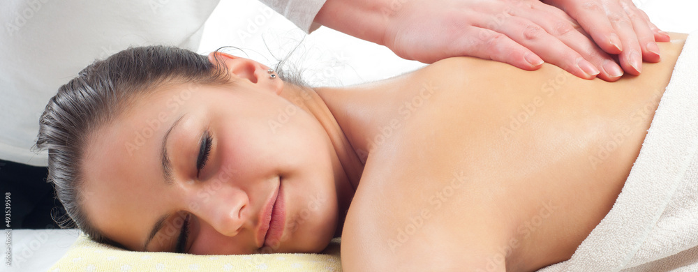 Girl getting back massage in massage salon, health spa