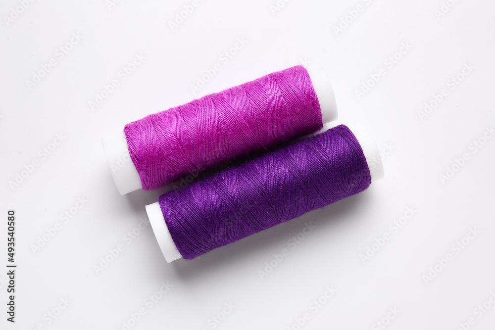 Different thread spools on white background Different thread spools on white background