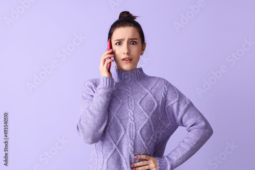 Worried young woman talking...