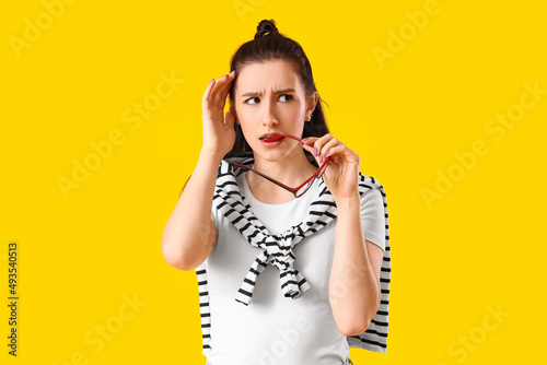Worried young woman on yell...