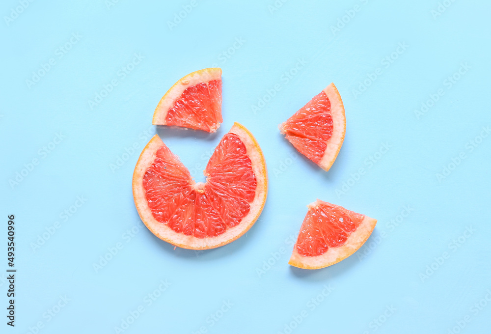Fresh grapefruit slices on blue background Fresh grapefruit slices on blue background