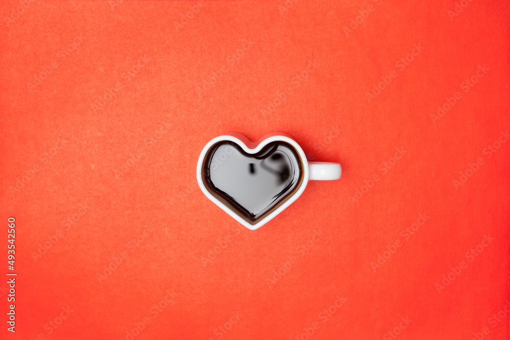 Heart shape coffee cups over red background. View from above. Heart shape coffee cups over red background. View from above.