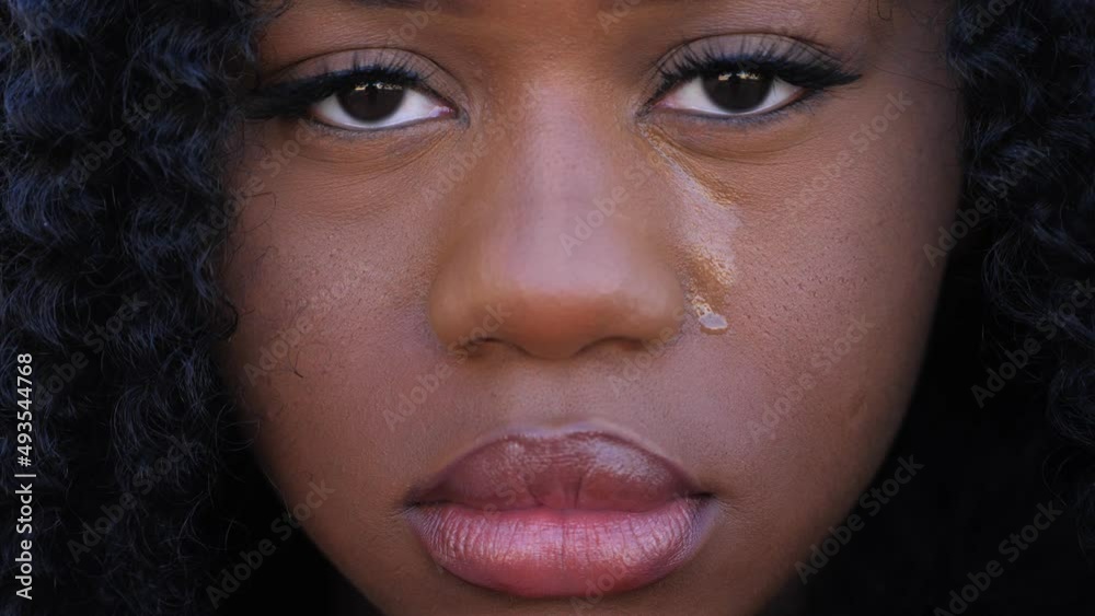 Sad african-american woman crying: upset depressed black teenager crying alone at home