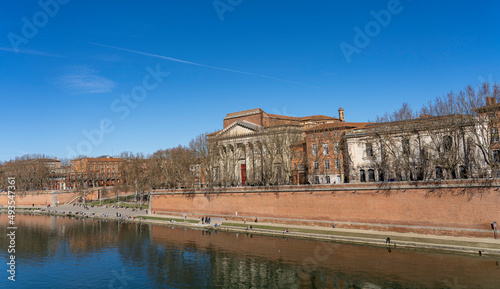 View from the water to the embankment of the river Garonne. City of Toulouse, France.