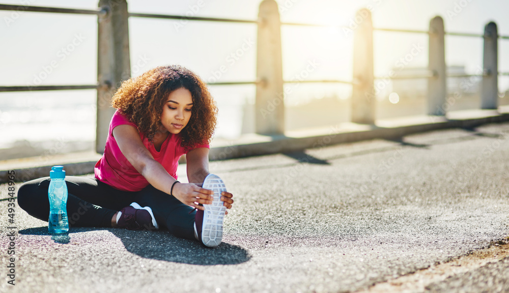Gotta keep those muscles loose. Shot of a sporty young woman doing warmup exercises outdoors. Gotta keep those muscles loose. Shot of a sporty young woman doing warmup exercises outdoors.
