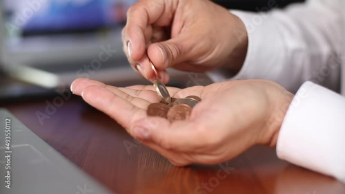 Businessman counting coins in the office