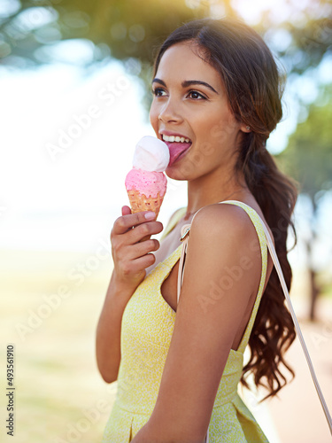Nothing beats ice cream. Shot of a young woman enjoying an ice cream.