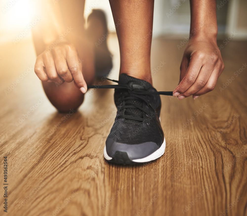 Get ready to run like your life depends on it. Cropped shot of a young woman tying her shoelaces. Get ready to run like your life depends on it. Cropped shot of a young woman tying her shoelaces.