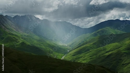Beautiful mountain landscape with rain clouds and sun rays in canyon, 4k